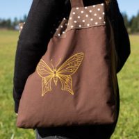 Dorothy in Catland - brown tote bag with polka dots and a yellow butterfly