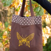 Dorothy in Catland - brown tote bag with polka dots and a yellow butterfly