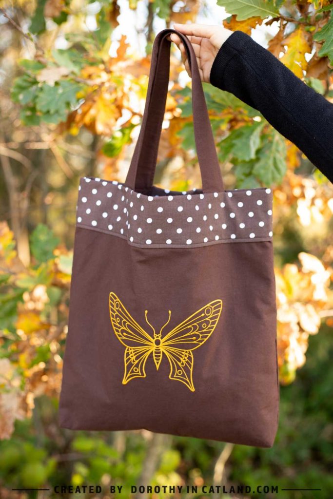 Dorothy in Catland - brown tote bag with polka dots and a yellow butterfly