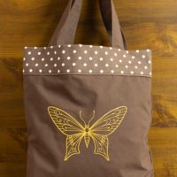 Dorothy in Catland - brown bag with white dots and a yellow butterfly