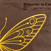 Dorothy in Catland - brown bag with white dots and a yellow butterfly