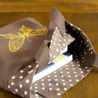 Dorothy in Catland - brown bag with white dots and a yellow butterfly