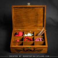 Dorothy in Catland - brown box with compartments and red moth