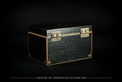 Black wooden jewellery box with a hand-painted golden flower on the lid and a golden bee inside, featuring antique bronze fittings.