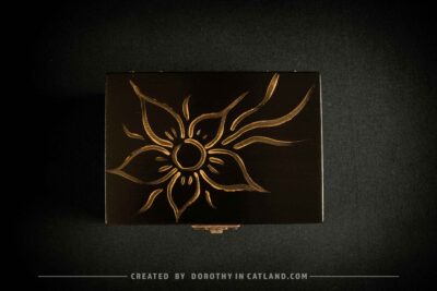 Black wooden jewellery box with a hand-painted golden flower on the lid and a golden bee inside, featuring antique bronze fittings.