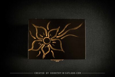 Black wooden jewellery box with a hand-painted golden flower on the lid and a golden bee inside, featuring antique bronze fittings.