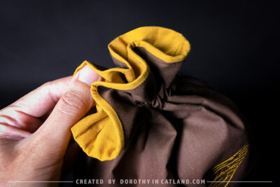 Dorothy in Catland - Brown sachet bag with a yellow butterfly