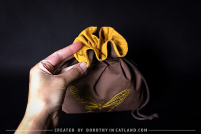 Dorothy in Catland - Brown sachet bag with a yellow butterfly