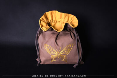 Dorothy in Catland - Brown sachet bag with a yellow butterfly