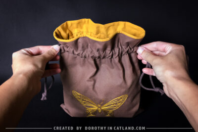 Dorothy in Catland - Brown sachet bag with a yellow butterfly