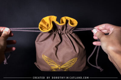 Dorothy in Catland - Brown sachet bag with a yellow butterfly