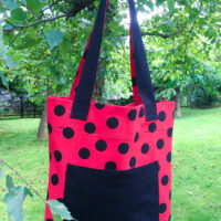 Dorothy in Catland - Red bag with large black polka dots