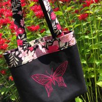 Light cotton shoulder bag with embroidered pink butterfly and floral motif