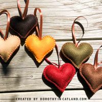 Handmade felt hearts in six autumn-inspired colors placed side by side