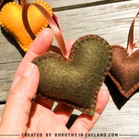 Close-up of a handmade green felt heart in rustic autumn style