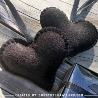 Two black felt hearts for Halloween with satin ribbons, handmade and elegant.